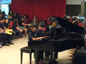 Two young maestros playing piano at our Kuala Belait recital