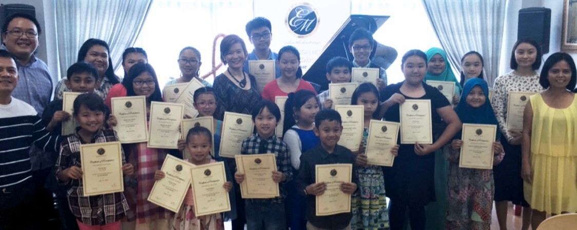 Young Music students posing with their certificates